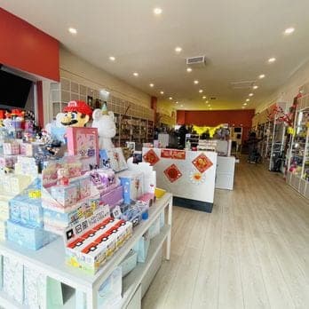 The imizzu shop floor — tables of blind boxes and a watermelon back wall